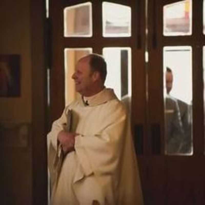 Father Dan Lobsinger Greeting People at the back of the Church