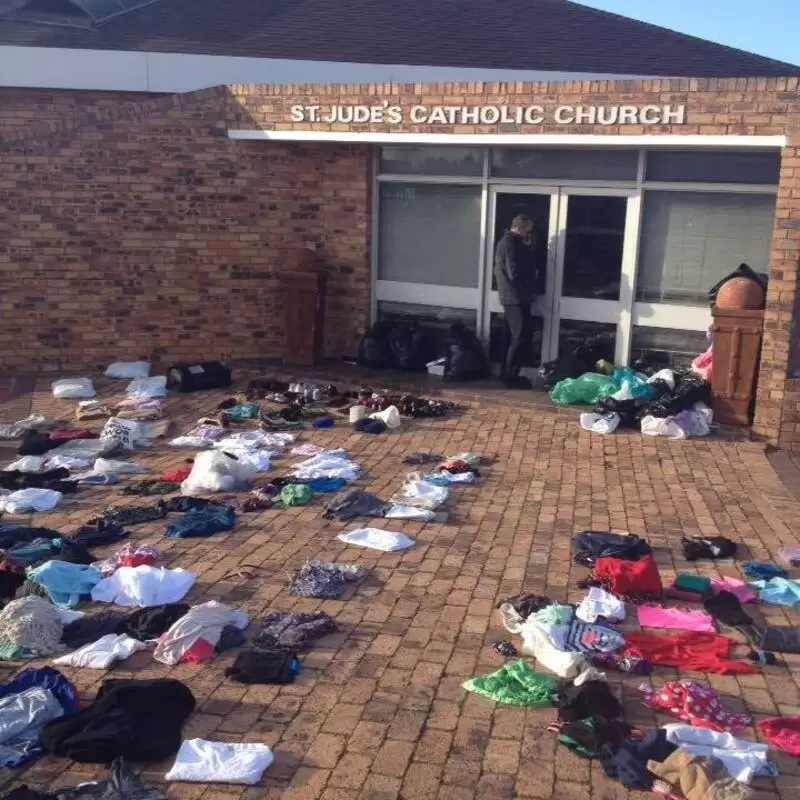 Sharing second hand clothing at our weekly feeding scheme crowd at St Jude's Catholic Church