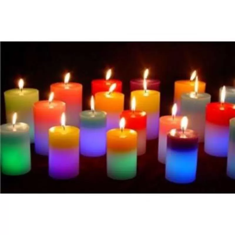 array of small, multicoloured candles, all lit