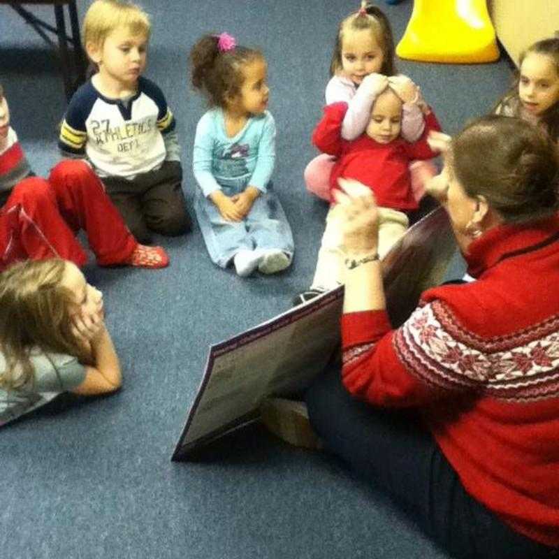 Teacher Terri reading to the kids about the Promised Land