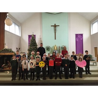 St Thomas Primary School children and Mrs Hamilton after Mass