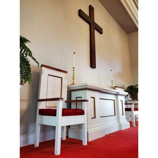 A hand-made cross adorns the wall of the sanctuary