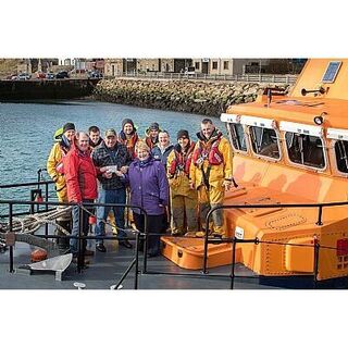 Lyall and Isabel handing over a cheque to Thurso Lifeboat