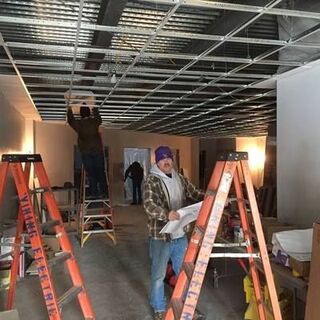 Building update - electricians are busy installing lights in the foyer