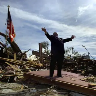 Pastor Lynn praising God at service 2 days after tornado