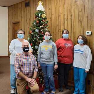 Celebrating Jesus's birth by putting up the Christmas tree at church.