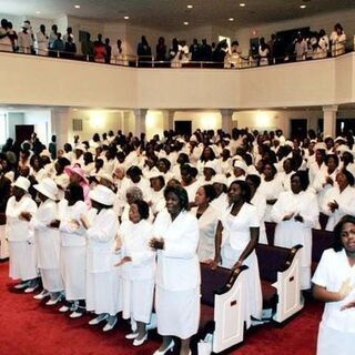 Congregation stands to sing the opening song during the evening worship service