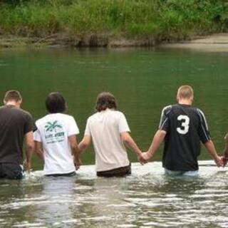 Walking out to be baptized at the church campout at Howard Miller Steelhead Park