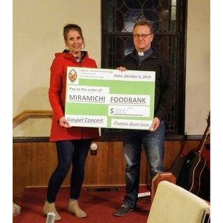 Rev. David Allan presenting the cheque to Jean Matchett, Coordinator at the Miramichi Community Food Bank