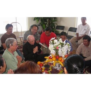 Redemptorist Fr. Don MacKinnon and Holy Family Sr. Michaela O'Connor participate in Kmhmu' community prayer - photo courtesy of The National Catholic Reporter Publishing Company