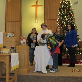 RyLeigh being baptized by pouring