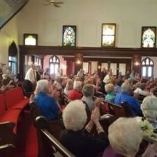 Members from Christ UMC, Laurel standing up to join the Centenary UMC after their church is closed